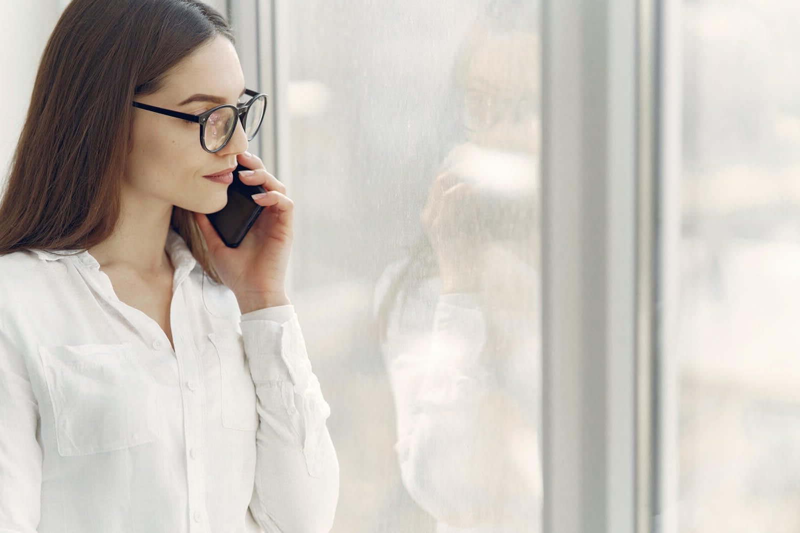 Young lady wearing glasses her mobile phone 