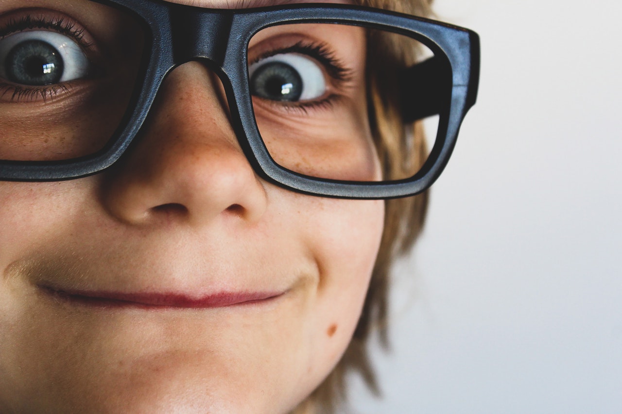 Smiling little kid with glasses